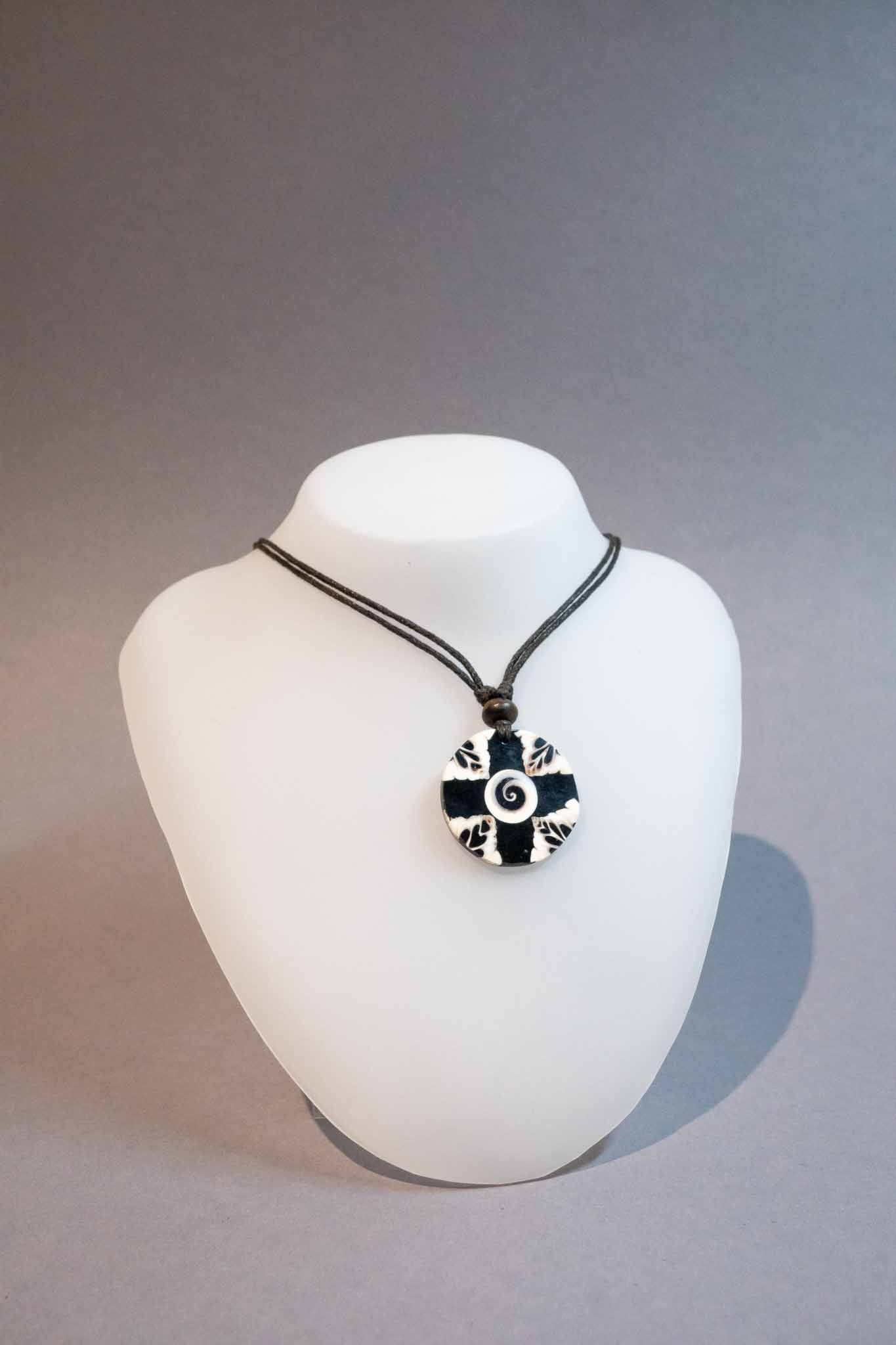 Schwarz-Weisser Anhaenger mit vier Quatranten und einer Spirale in der Mitte